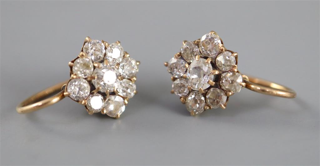A pair of early 20th century gold and nine stone old cut diamond cluster earrings,